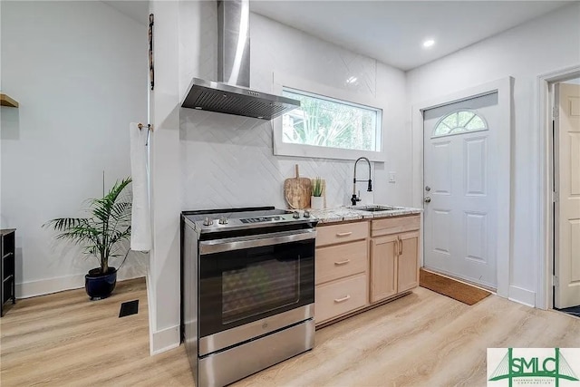 528 E Gordon Ln, Savannah, GA 31401 - kitchen featuring stainless steel range with electric cooktop, wall chimney range hood, a sink, light wood-style flooring, and recessed lighting