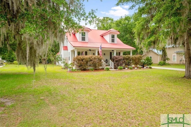 186 Goodman Dr, Midway, GA 31320 - new england style home with a porch, a front yard, metal roof, and ceiling fan