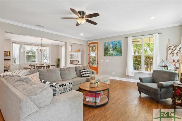 186 Goodman Dr, Midway, GA 31320 - living room with plenty of natural light, baseboards, light wood finished floors, a ceiling fan, and ornamental molding