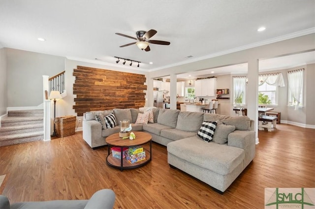 186 Goodman Dr, Midway, GA 31320 - living area with stairway, baseboards, a ceiling fan, crown molding, and light wood-style flooring