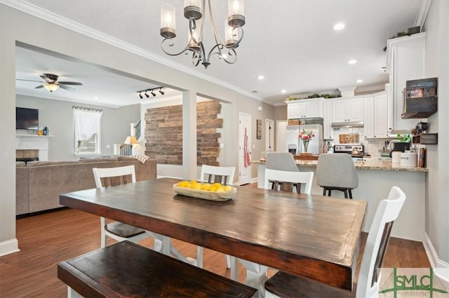 186 Goodman Dr, Midway, GA 31320 - dining space featuring wood finished floors, recessed lighting, a ceiling fan, a chandelier, and crown molding