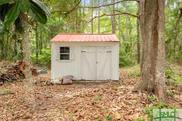 186 Goodman Dr, Midway, GA 31320 - view of shed featuring a wooded view