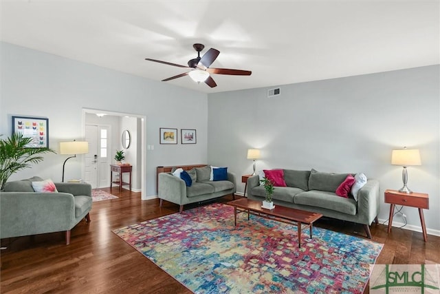 living area featuring a ceiling fan, wood finished floors, and baseboards