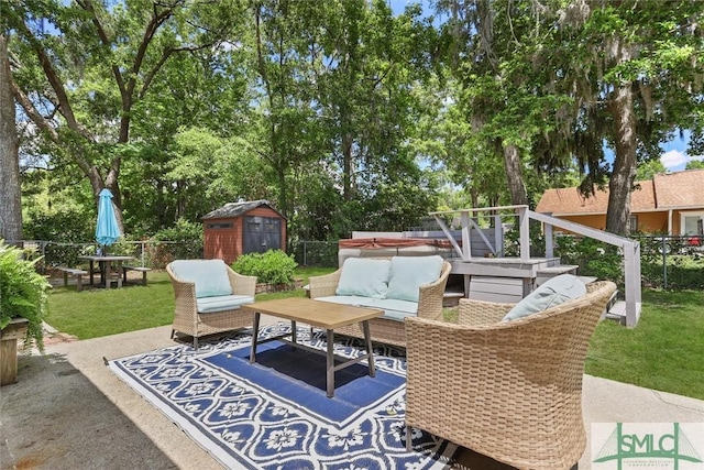 view of patio / terrace featuring an outdoor hangout area, a shed, and an outbuilding