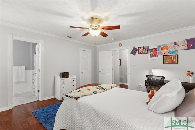 bedroom with wood finished floors, crown molding, ceiling fan, ensuite bathroom, and baseboards