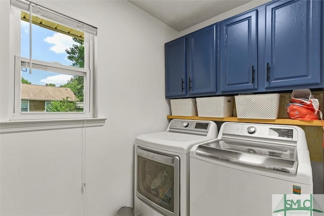 laundry room featuring cabinet space and washer and clothes dryer
