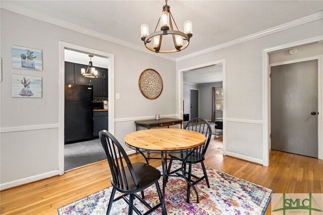 21 Berkley Pl, Savannah, GA 31405 - dining area with a chandelier, hardwood / wood-style flooring, ornamental molding, and baseboards