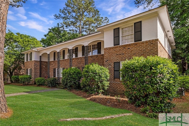 21 Berkley Pl, Savannah, GA 31405 - view of front of home featuring brick siding, a front lawn, and covered porch