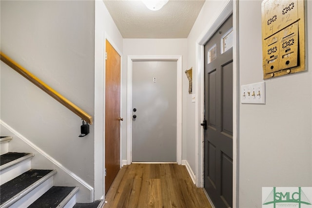 21 Berkley Pl, Savannah, GA 31405 - doorway with wood finished floors, stairs, a textured ceiling, and baseboards