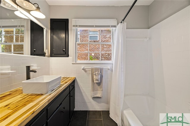 21 Berkley Pl, Savannah, GA 31405 - full bath featuring tile patterned floors, tile walls, vanity, shower / bath combo, and a wainscoted wall
