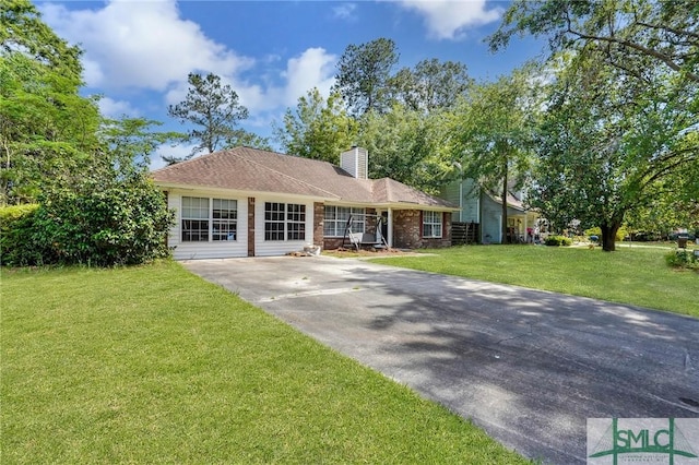 11 Pelican Ct, Richmond Hill, GA 31324 - ranch-style house featuring a chimney, a front yard, and concrete driveway