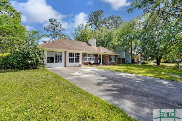 11 Pelican Ct, Richmond Hill, GA 31324 - ranch-style house with a chimney, a front lawn, and concrete driveway