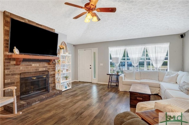 11 Pelican Ct, Richmond Hill, GA 31324 - living room with a textured ceiling, wood finished floors, ceiling fan, a fireplace, and baseboards