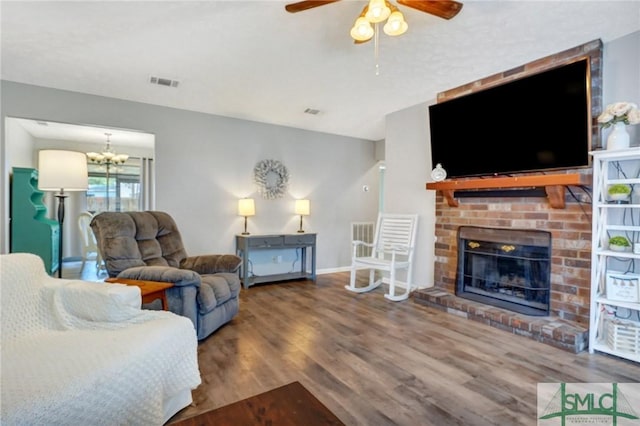 11 Pelican Ct, Richmond Hill, GA 31324 - living area with a ceiling fan, a brick fireplace, wood finished floors, a chandelier, and baseboards