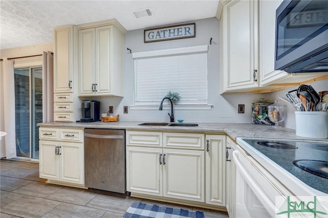 11 Pelican Ct, Richmond Hill, GA 31324 - kitchen featuring stainless steel dishwasher, a sink, cream cabinetry, light countertops, and a textured ceiling