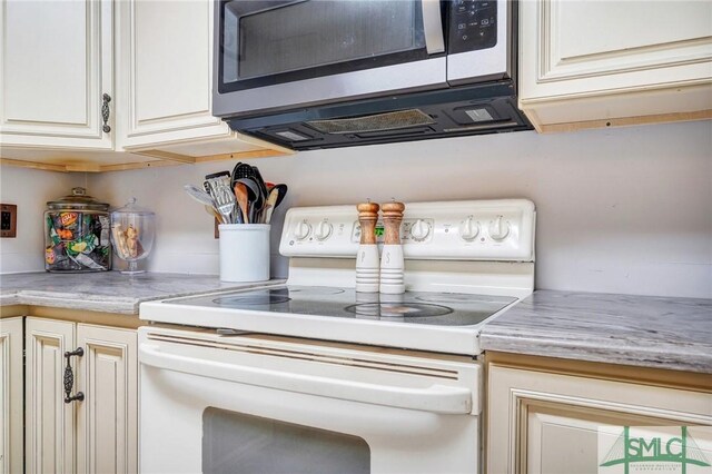 11 Pelican Ct, Richmond Hill, GA 31324 - kitchen view of white range with electric cooktop, stainless steel microwave, and light countertops