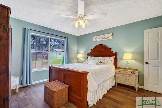 11 Pelican Ct, Richmond Hill, GA 31324 - bedroom with dark wood-style flooring, baseboards, a textured ceiling, and a ceiling fan