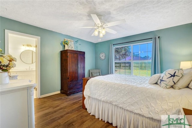 11 Pelican Ct, Richmond Hill, GA 31324 - bedroom featuring wood finished floors, a textured ceiling, baseboards, ceiling fan, and ensuite bathroom