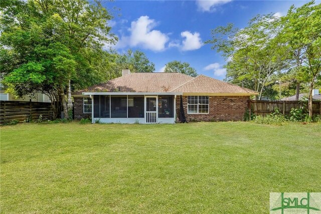 11 Pelican Ct, Richmond Hill, GA 31324 - back of house featuring a sunroom, a chimney, and brick siding