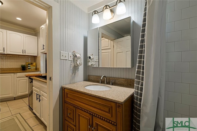 bathroom with tile patterned flooring, vanity, tiled shower, decorative backsplash, and ornamental molding
