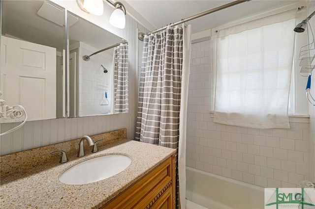 bathroom with shower / bath combo with shower curtain and vanity
