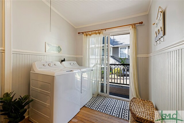 laundry area with separate washer and dryer, wainscoting, wood finished floors, and ornamental molding