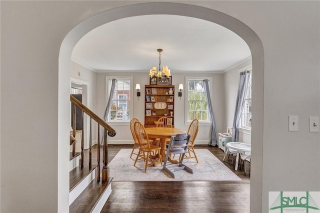 19 E 54th St, Savannah, GA 31405 - dining room with arched walkways, plenty of natural light, dark wood-type flooring, and ornamental molding