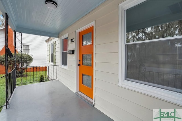 view of exterior entry featuring covered porch