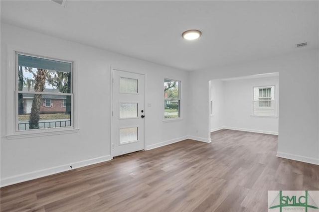foyer featuring wood finished floors and baseboards