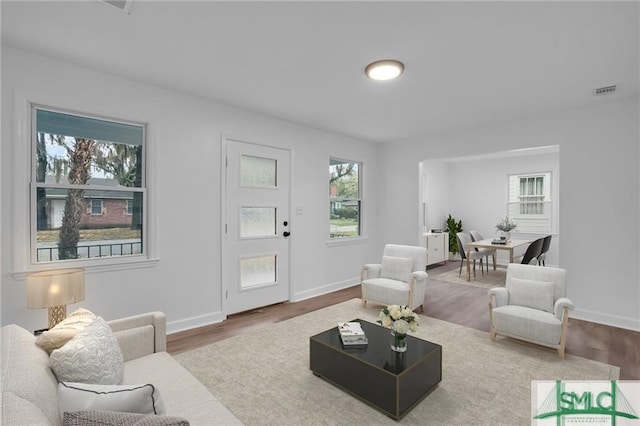 living area with wood finished floors and baseboards