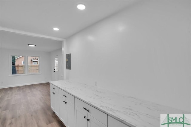 hallway with electric panel, wood finished floors, recessed lighting, and baseboards