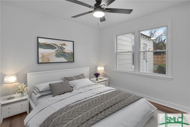 bedroom featuring wood finished floors, baseboards, and a ceiling fan