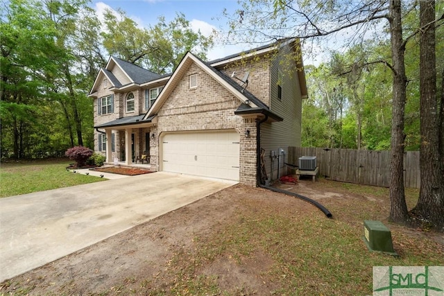 view of front of property featuring brick siding, driveway, an attached garage, and central air condition unit
