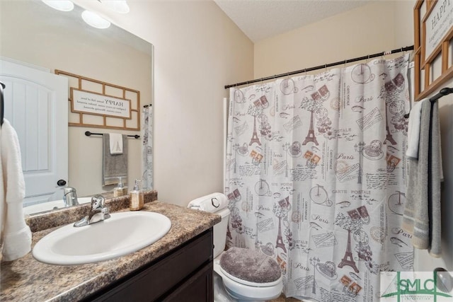 bathroom with toilet, vanity, and curtained shower