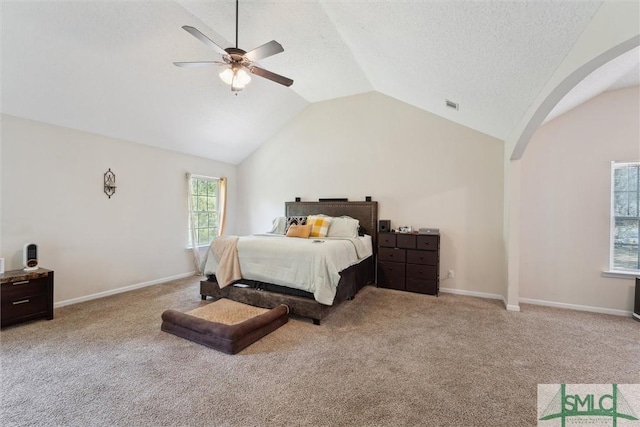carpeted bedroom featuring arched walkways, vaulted ceiling, ceiling fan, and baseboards