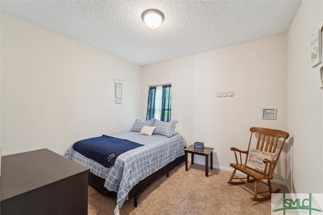 bedroom featuring a textured ceiling and light colored carpet