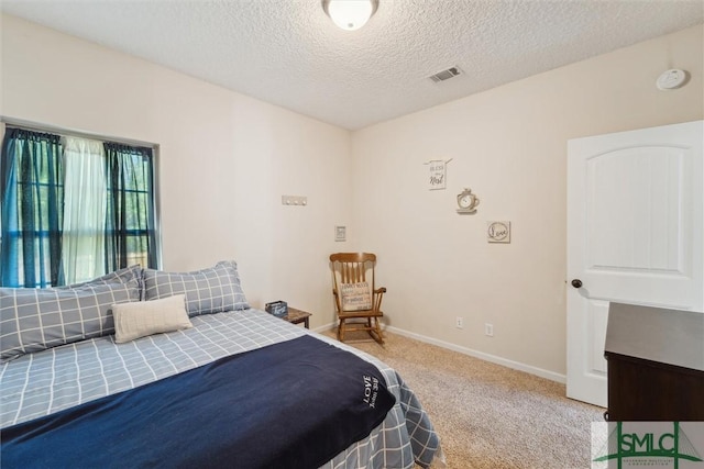 bedroom with carpet, a textured ceiling, and baseboards
