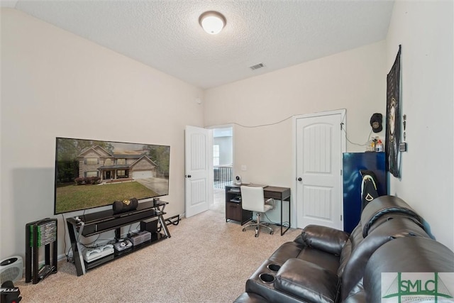 carpeted office space featuring a textured ceiling