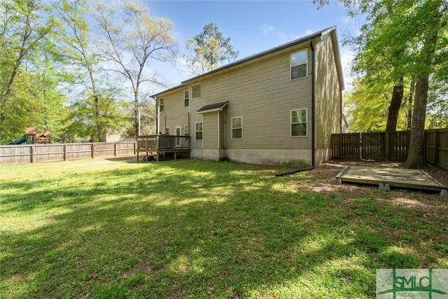 rear view of property featuring a wooden deck