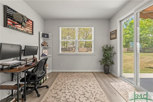 office area with light wood finished floors and baseboards