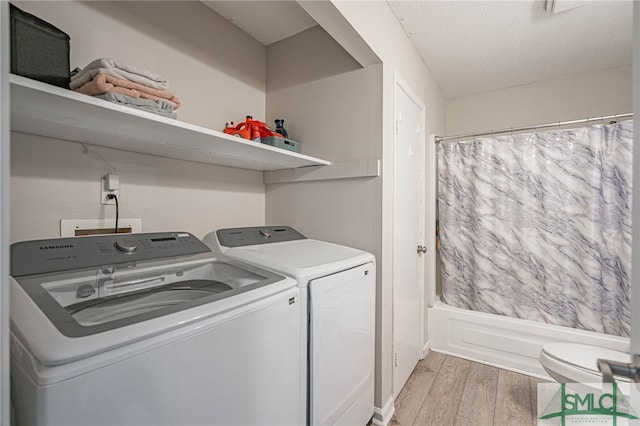 938 Greenbriar Trl, Hinesville, GA 31313 - laundry room featuring separate washer and dryer, light wood-style floors, and a textured ceiling