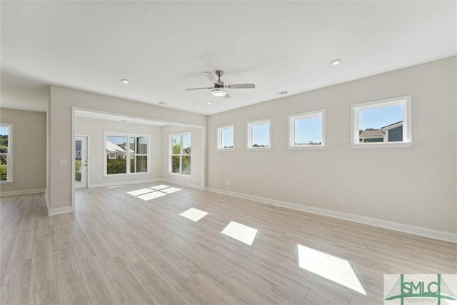 unfurnished living room with baseboards, ceiling fan, healthy amount of natural light, light wood finished floors, and recessed lighting