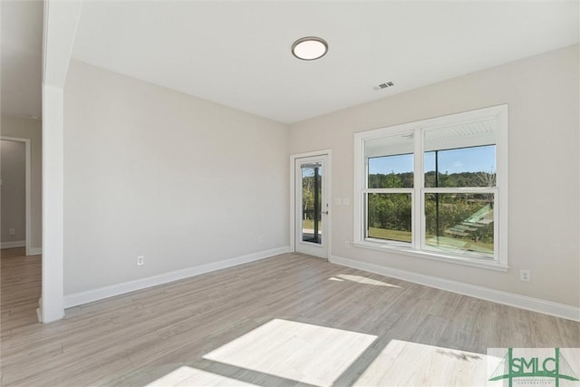 152 Harvest Hl, Pooler, GA 31322 - unfurnished living room with light wood finished floors and baseboards