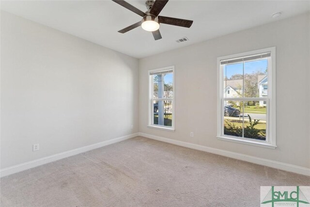 carpeted empty room with baseboards and healthy amount of natural light