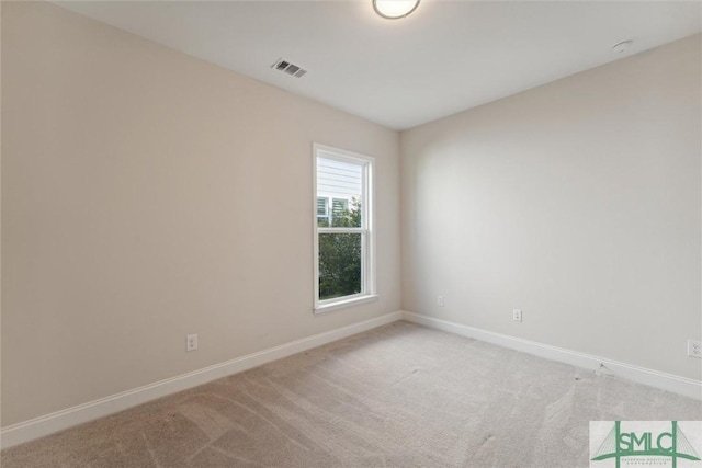unfurnished room with baseboards and light carpet