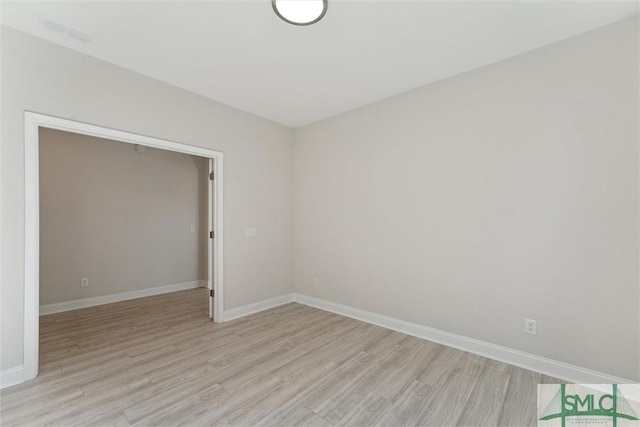 unfurnished room featuring light wood-style floors and baseboards