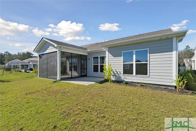back of house featuring a sunroom, a lawn, and a patio