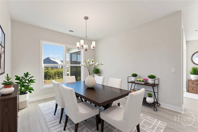 152 Harvest Hl, Pooler, GA 31322 - dining space with a chandelier, light wood-style flooring, and baseboards