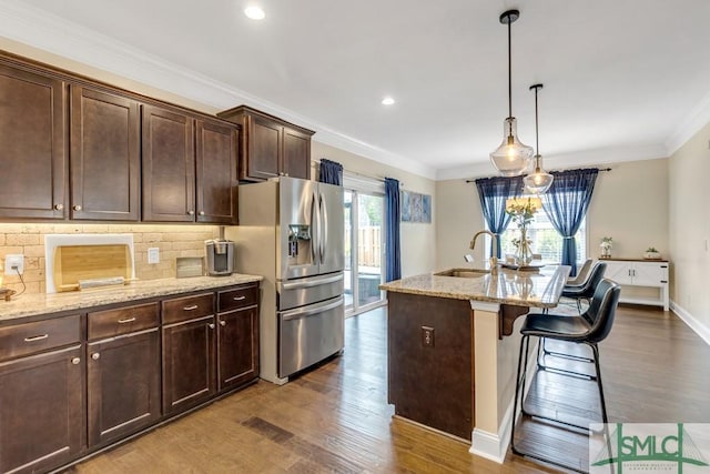 kitchen featuring a sink, stainless steel fridge with ice dispenser, dark wood-style flooring, backsplash, and dark brown cabinets