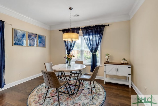 dining room featuring dark wood-style floors, crown molding, and baseboards